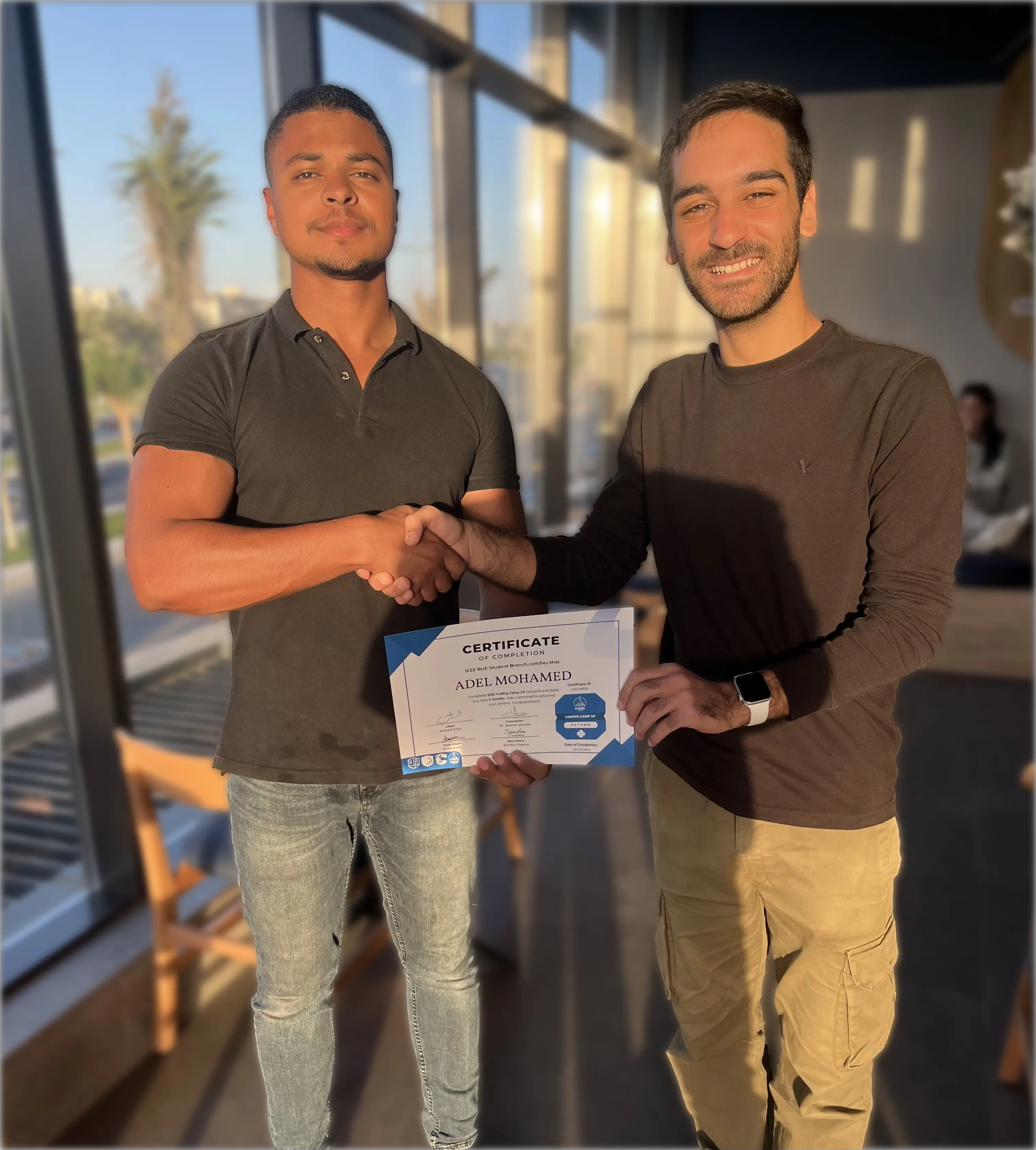 Adel with IEEE BUE Student Branch president Ahmed El-Sisi while holding the Python Coding Camp certificate